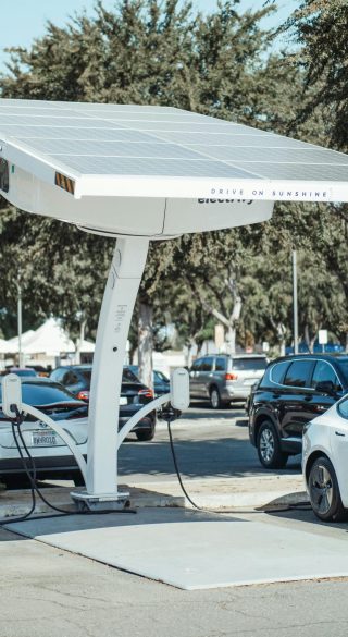 pexels-photo-9800036-9800036-1 Eco-friendly solar panel charging station for electric vehicles outdoors.